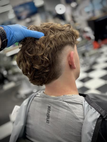 Curly mullet with a burst fade at Salt City Barber Shop in Liverpool, NY