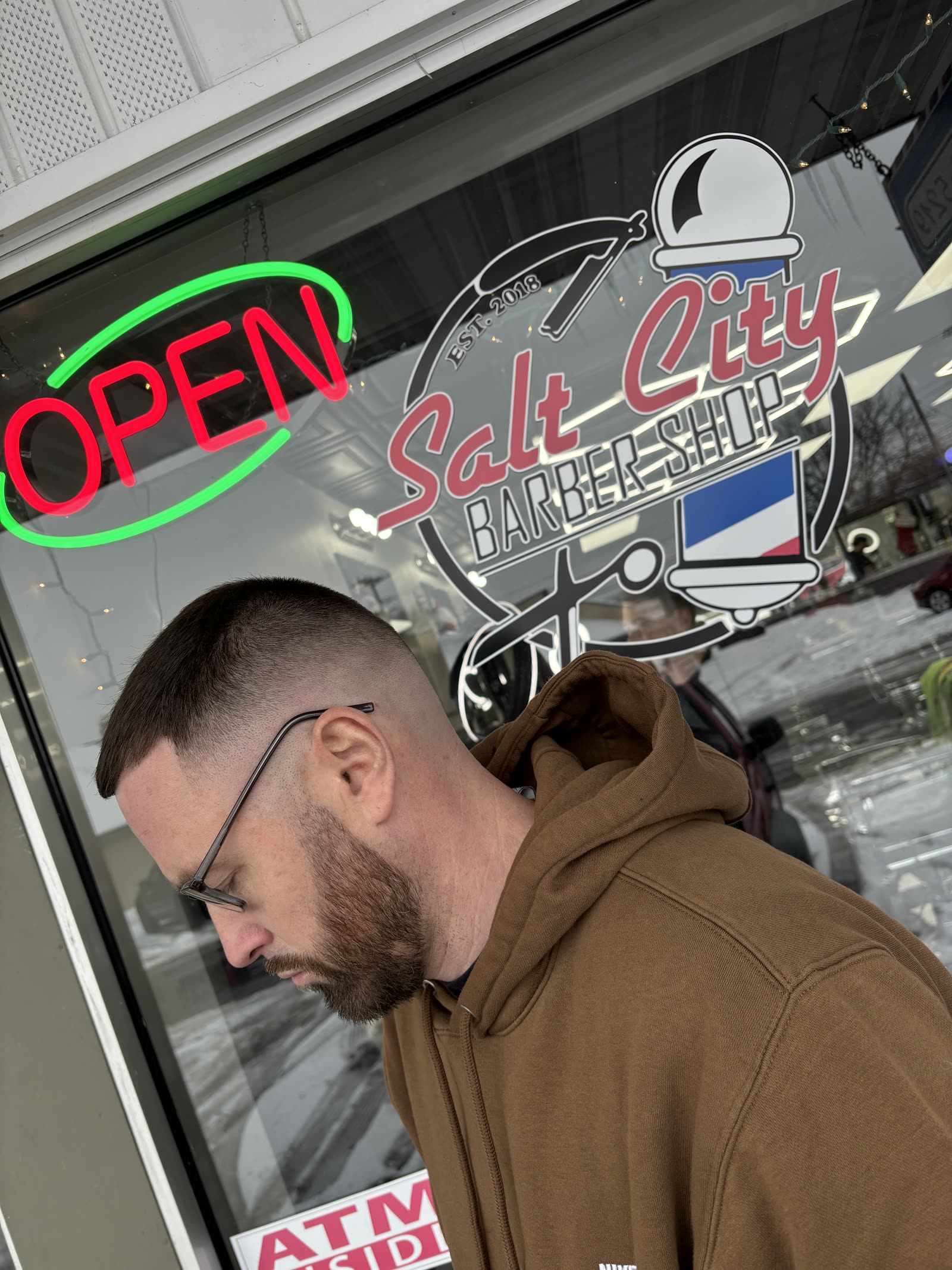 Salt City Barber Shop storefront on Oswego St in Liverpool, NY with the OPEN sign lit